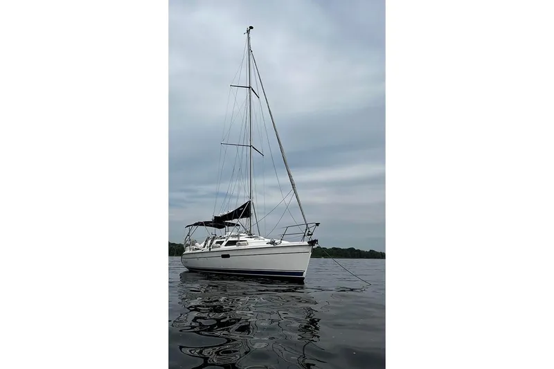 Slide: The Image of 2001 Marlow-Hunter 320 sailboat on calm water under cloudy sky. - 3