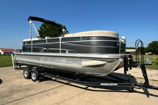 The Image of 2014 Veranda Relax V2275RC pontoon boat on trailer, parked outdoors under clear blue sky. - 0