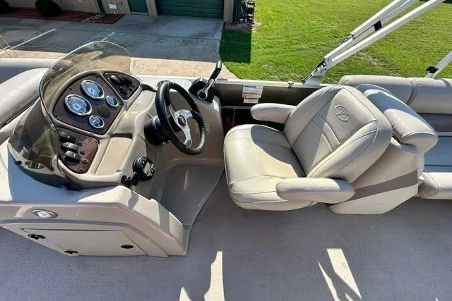 Slide: The Image of 2014 Veranda Relax V2275RC boat interior with steering console and plush seating. - 12