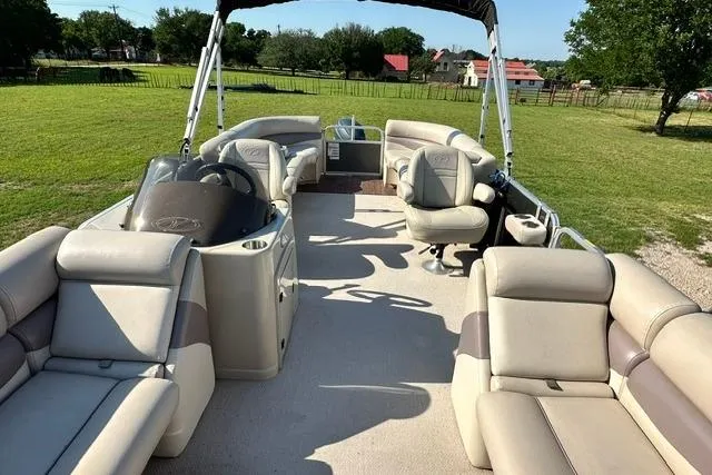 Slide: The Image of 2014 Veranda Relax V2275RC pontoon boat with spacious seating on a grassy field. - 5