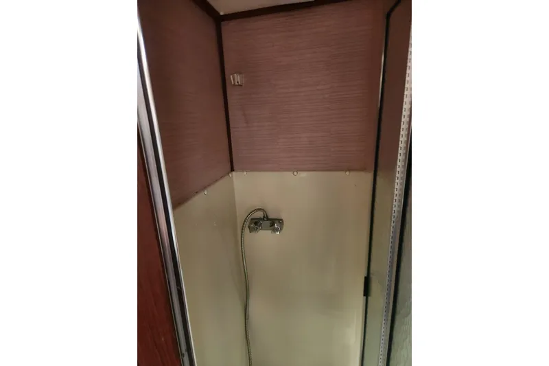 Slide: The Image of Shower area inside 1987 Luhrs 40 Convertible boat, featuring a compact design. - 10