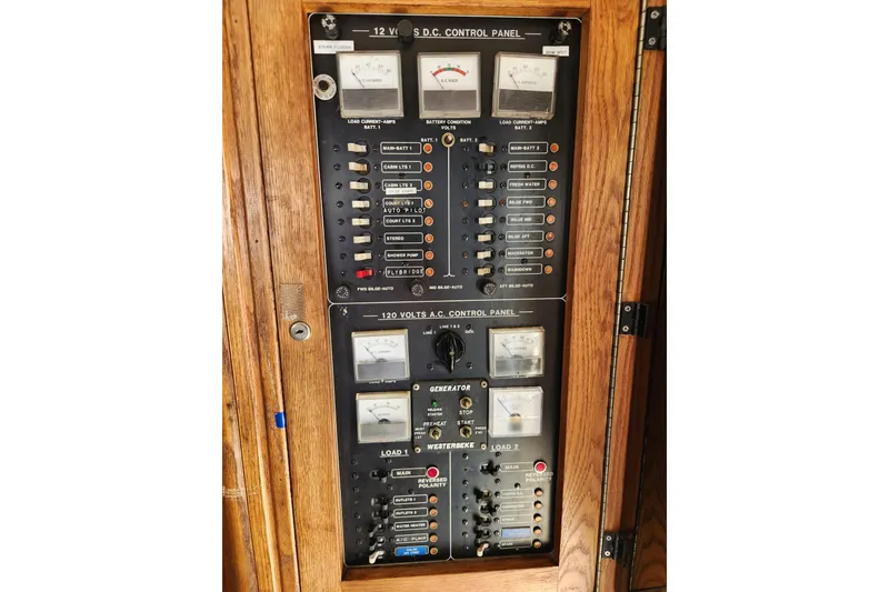 Slide: The Image of Electrical control panel on a 1987 Luhrs 40 Convertible boat, featuring gauges and switches. - 12