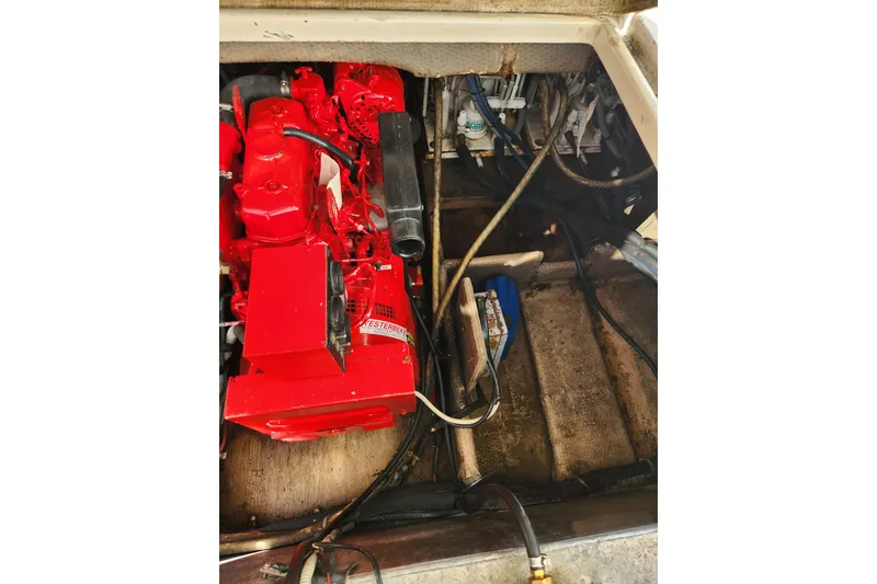 Slide: The Image of Engine compartment of a 1987 Luhrs 40 Convertible boat with visible red engine components. - 17