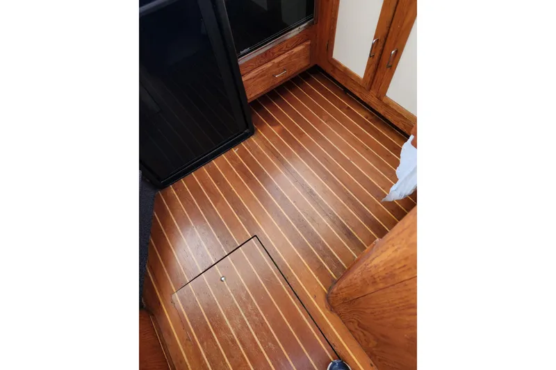 Slide: The Image of 1987 Luhrs 40 Convertible interior with polished wooden flooring and cabinetry. - 26