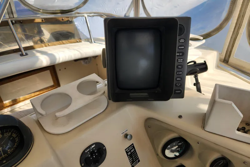 Slide: The Image of 1987 Luhrs 40 Convertible boat dashboard with navigation equipment and controls. - 27