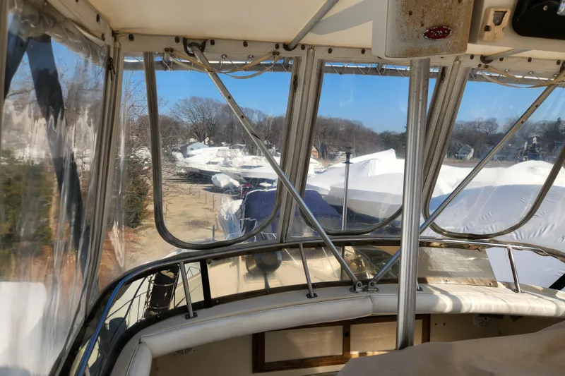 Slide: The Image of 1987 Luhrs 40 Convertible boat interior view with covered boats outside. - 29