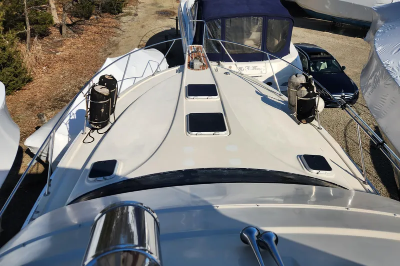 Slide: The Image of 1987 Luhrs 40 Convertible yacht deck view with railings and hatches. - 34