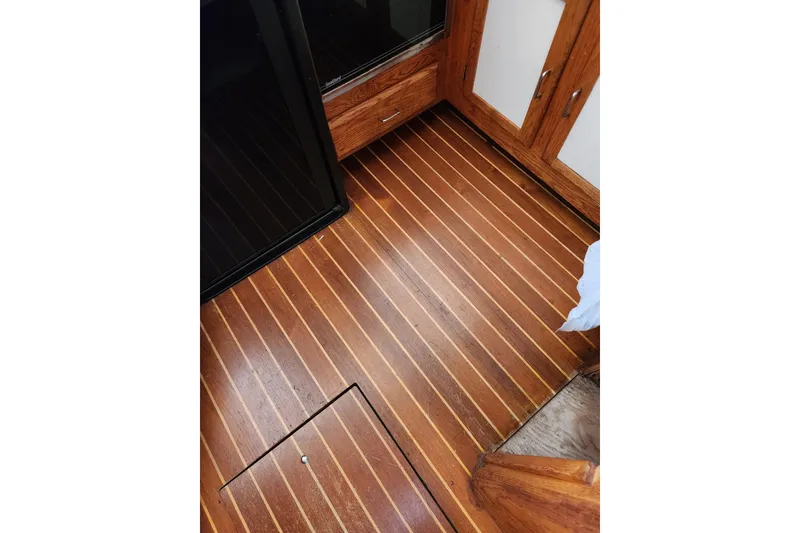 Slide: The Image of 1987 Luhrs 40 Convertible interior with polished wooden flooring and cabinetry. - 36