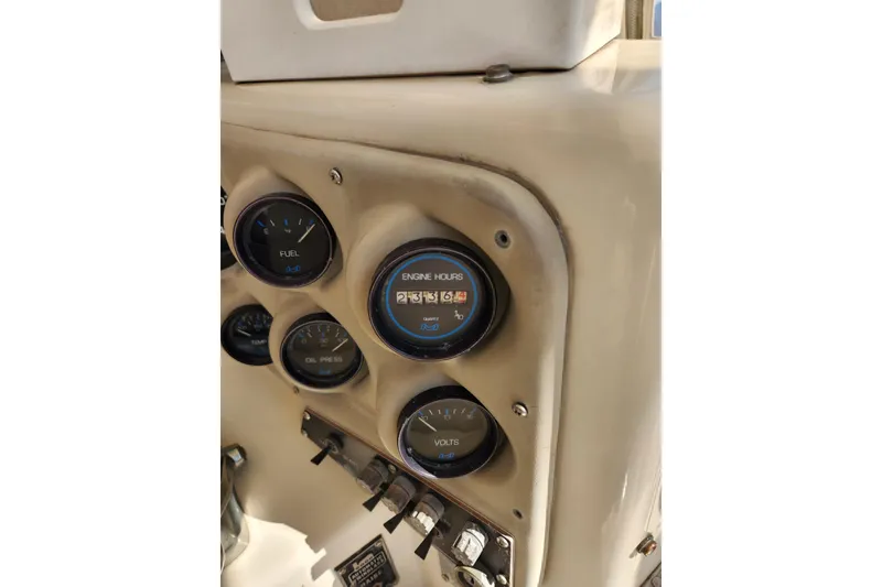 Slide: The Image of 1987 Luhrs 40 Convertible dashboard with fuel, engine hours, oil pressure, and volts gauges. - 38