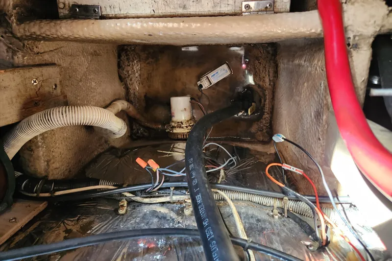 Slide: The Image of Engine compartment of a 1987 Luhrs 40 Convertible boat, showing hoses and wiring. - 42
