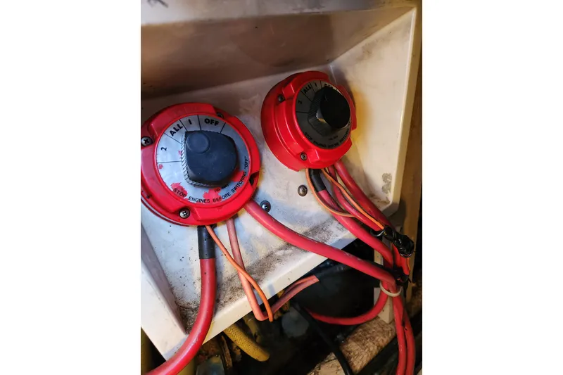 Slide: The Image of Battery switches on a 1987 Luhrs 40 Convertible boat with red cables. - 44