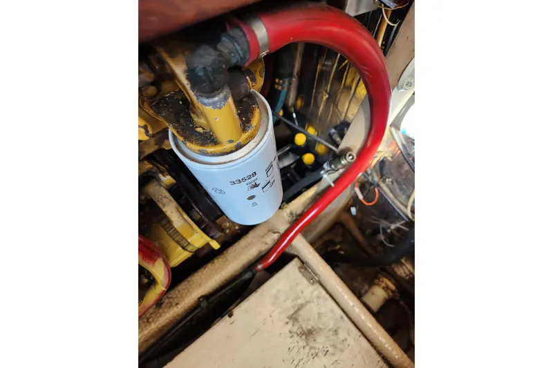Slide: The Image of Engine compartment of 1987 Luhrs 40 Convertible with visible fuel filter and red hose. - 46