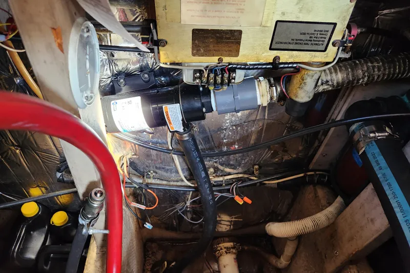 Slide: The Image of Engine room of a 1987 Luhrs 40 Convertible boat, showcasing mechanical components and wiring. - 47