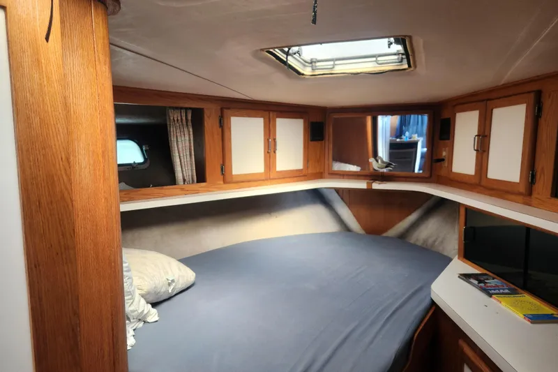 Slide: The Image of Cozy cabin interior of 1987 Luhrs 40 Convertible boat with wooden cabinets and skylight. - 7