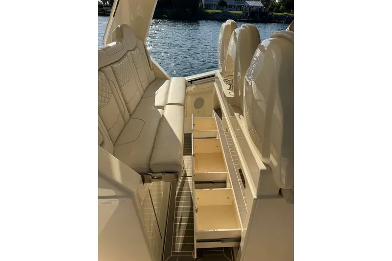 Slide: The Image of 2025 Scout 425 LXF boat interior with luxurious seating and open storage drawers. - 31