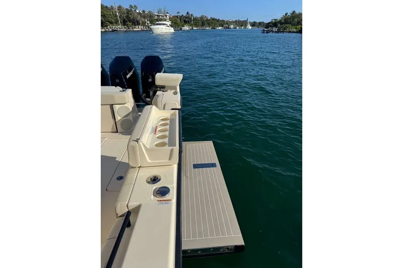 Slide: The Image of 2025 Scout 425 LXF boat with outboard motors on a scenic waterway. - 35