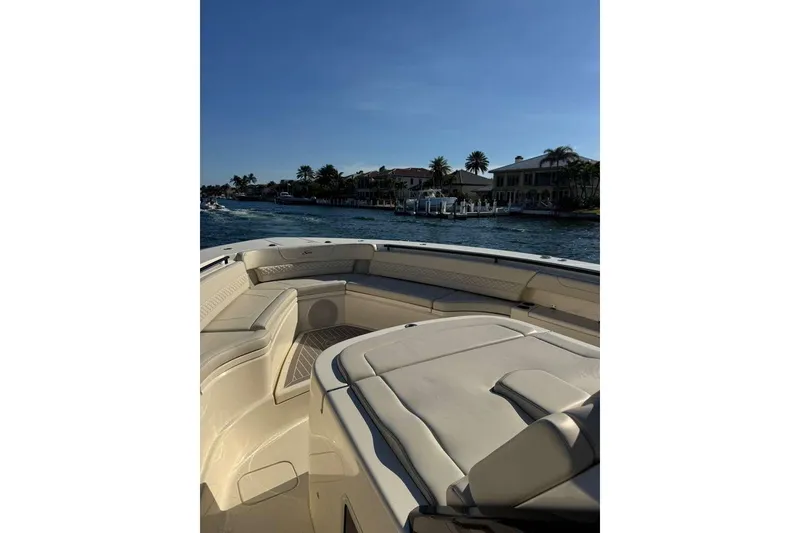 Slide: The Image of 2025 Scout 425 LXF boat interior with waterfront view and luxury seating. - 36