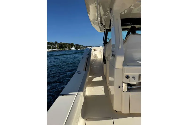 Slide: The Image of 2025 Scout 425 LXF boat cruising on a sunny day, showcasing sleek design and luxury features. - 40