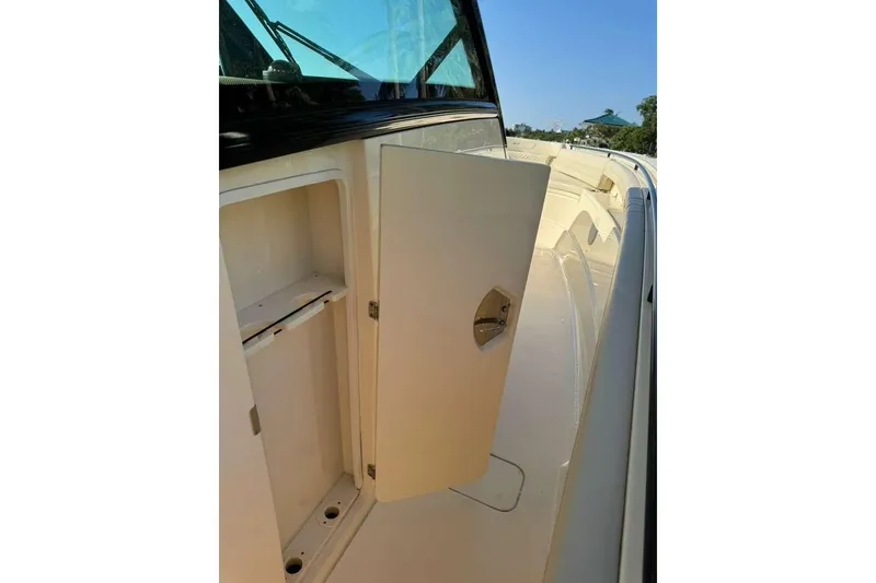Slide: The Image of 2025 Scout 425 LXF boat interior storage compartment with open door. - 44