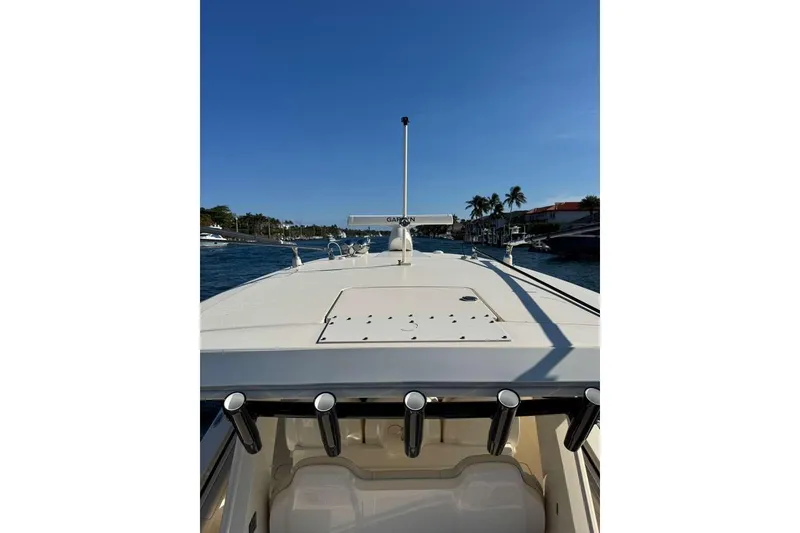 Slide: The Image of 2025 Scout 425 LXF boat deck view with clear blue sky and waterfront scenery. - 47
