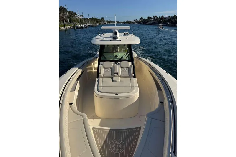 Slide: The Image of 2025 Scout 425 LXF boat cruising on a sunny day, showcasing luxurious seating and sleek design. - 48