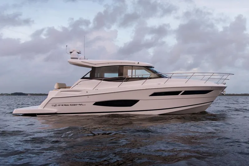 Slide: The Image of Manufacturer Provided Image: 2026 Regal 38 Grande Coupe yacht cruising on open water under cloudy skies. - 3
