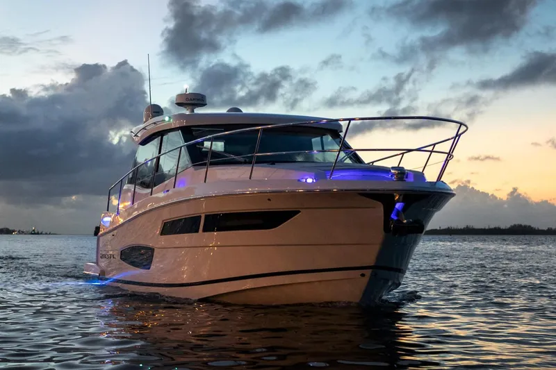 Slide: The Image of Manufacturer Provided Image: 2026 Regal 38 Grande Coupe yacht cruising at sunset on calm waters. - 4