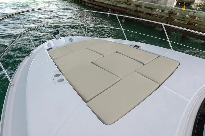 Slide: The Image of Manufacturer Provided Image: 2026 Regal 38 Grande Coupe boat with spacious sunbathing deck on calm water. - 6
