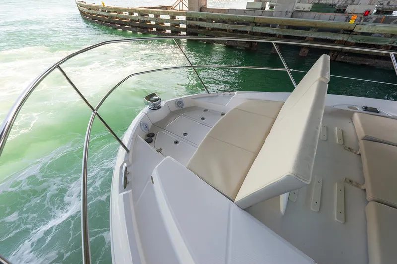 Slide: The Image of Manufacturer Provided Image: 2026 Regal 38 Grande Coupe boat with sleek seating, cruising on turquoise water. - 7