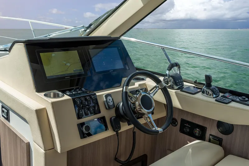 Slide: The Image of Manufacturer Provided Image: Helm of 2026 Regal 38 Grande Coupe yacht with modern navigation controls. - 9