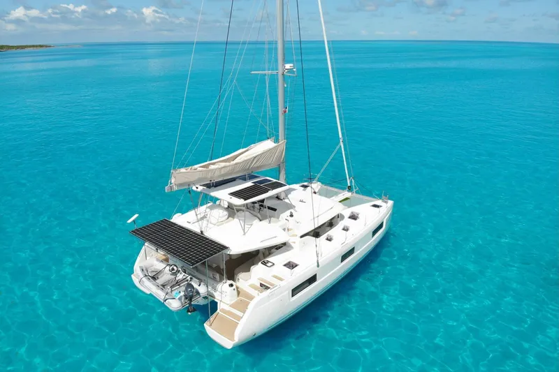 The Image of 2022 Lagoon 46 catamaran sailing on clear turquoise waters under a sunny sky. - 0