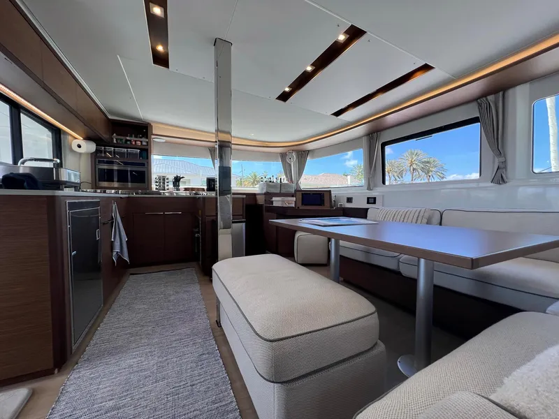 Slide: The Image of Interior of a 2022 Lagoon 46 yacht, featuring modern kitchen and seating area. - 16