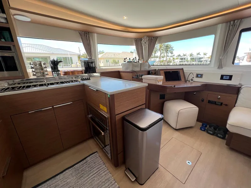 Slide: The Image of Interior of a 2022 Lagoon 46 yacht, featuring modern kitchen and seating area. - 18