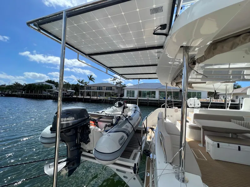 Slide: The Image of 2022 Lagoon 46 catamaran with solar panels and dinghy. - 2