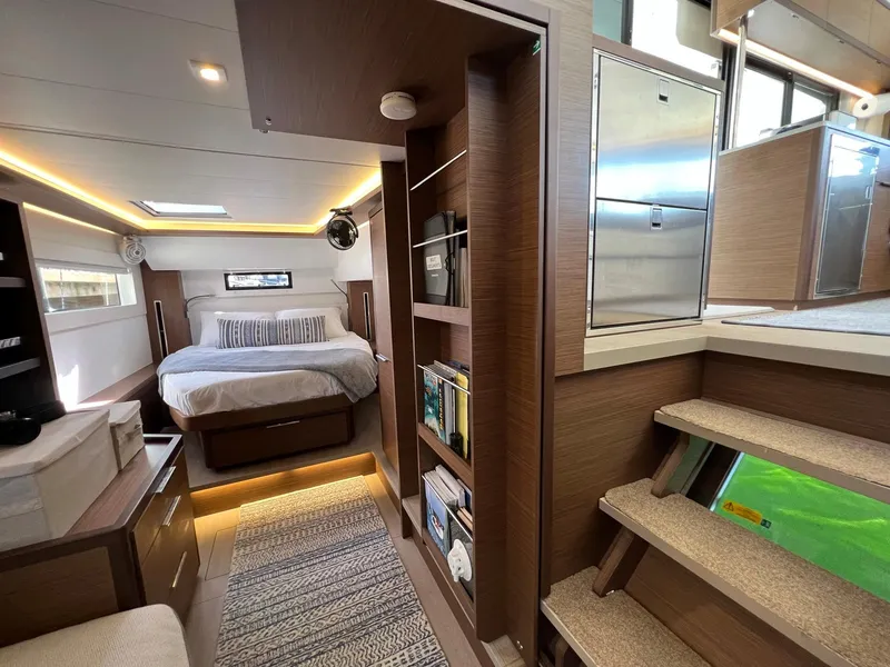 Slide: The Image of Interior of a 2022 Lagoon 46 yacht featuring a modern bedroom. - 23
