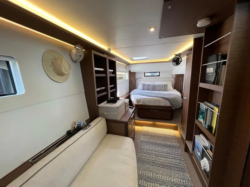 Slide: The Image of Interior of a 2022 Lagoon 46 yacht with cozy bedroom and shelves. - 24