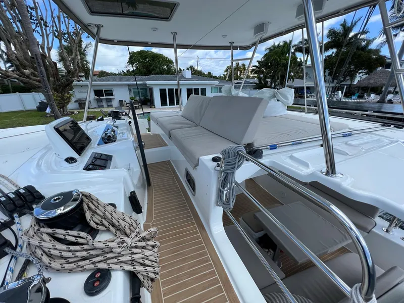 Slide: The Image of 2022 Lagoon 46 catamaran with modern cockpit design and comfortable seating areas. - 7