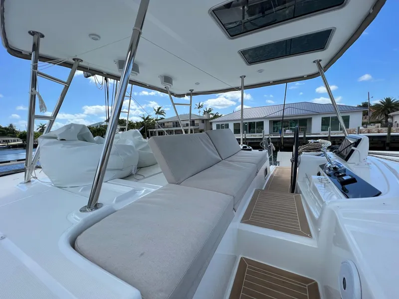 Slide: The Image of 2022 Lagoon 46 catamaran with spacious deck and seating area. - 8