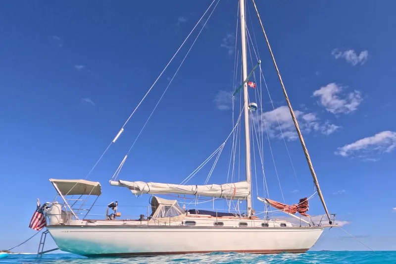 The Image of 1988 Cape Dory 36 sailboat on clear blue water under a bright sky. - 0