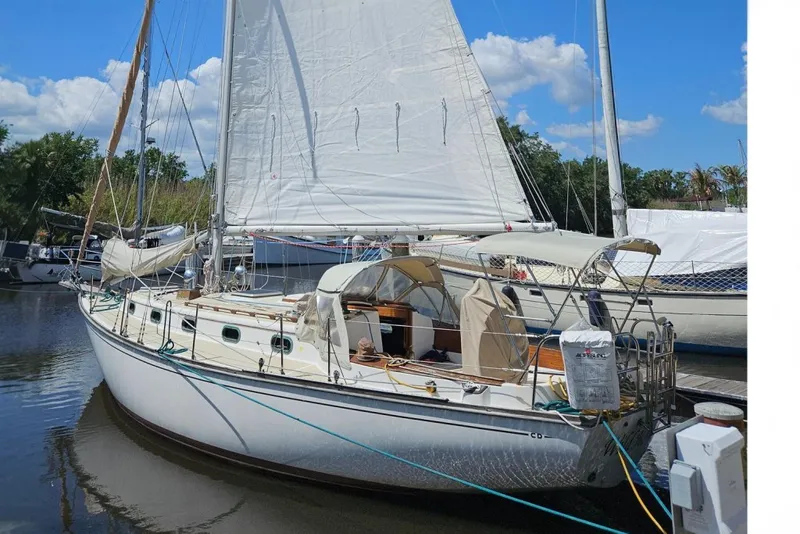 The Image of Sailboat Cape Dory 38, 1988 model, docked under a clear blue sky. - 0