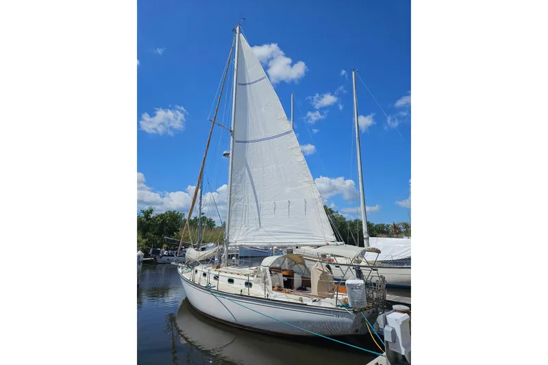 Slide: The Image of Sailboat Cape Dory 38, 1988 model, docked under a clear blue sky. - 1