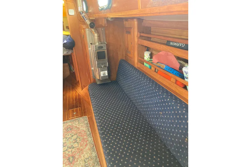 Slide: The Image of Interior of 1988 Cape Dory 36 sailboat with cozy seating and wood paneling. - 16