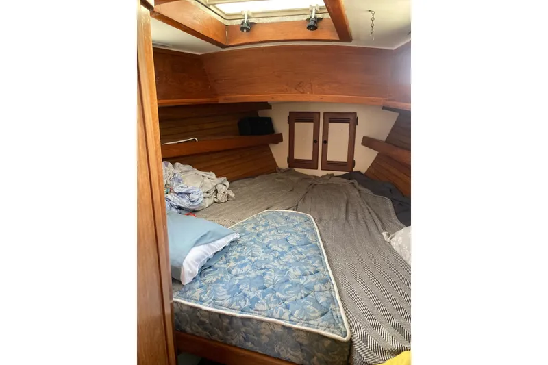 Slide: The Image of Cozy cabin interior of 1988 Cape Dory 36 sailboat with wooden accents and bedding. - 17