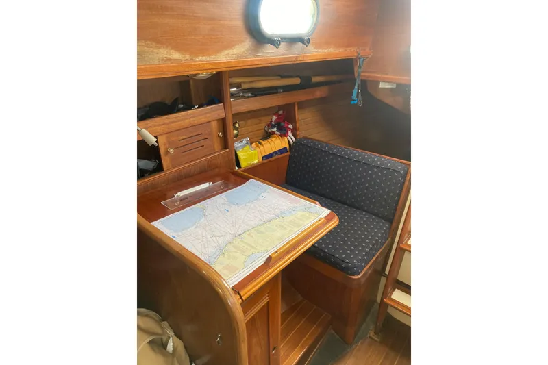 Slide: The Image of Navigation station inside 1988 Cape Dory 36 sailboat with chart table and seating. - 18