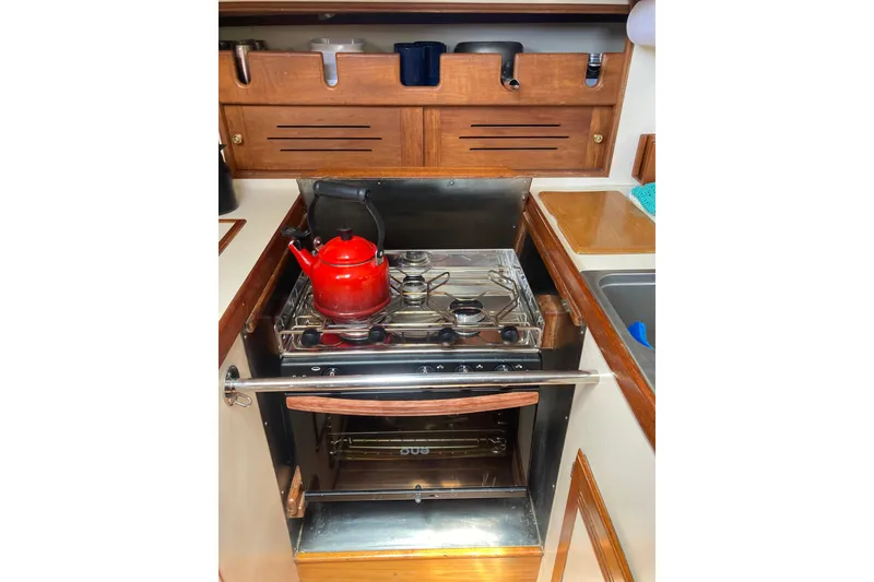 Slide: The Image of Galley kitchen in 1988 Cape Dory 36 sailboat with stove and red kettle. - 19