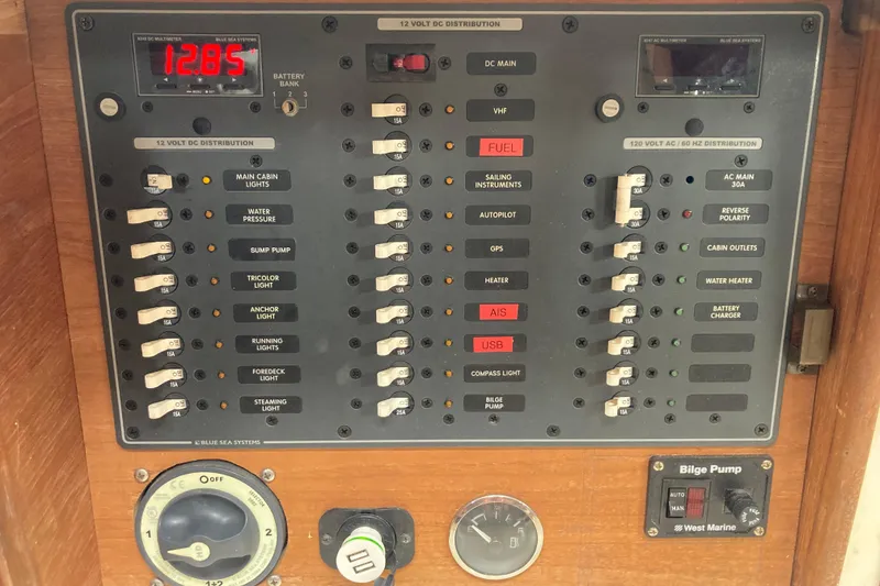 Slide: The Image of Electrical control panel on a 1988 Cape Dory 36 sailboat, featuring switches and voltage display. - 21