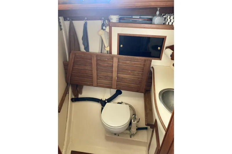 Slide: The Image of 1988 Cape Dory 36 yacht bathroom with wooden accents and compact design. - 23