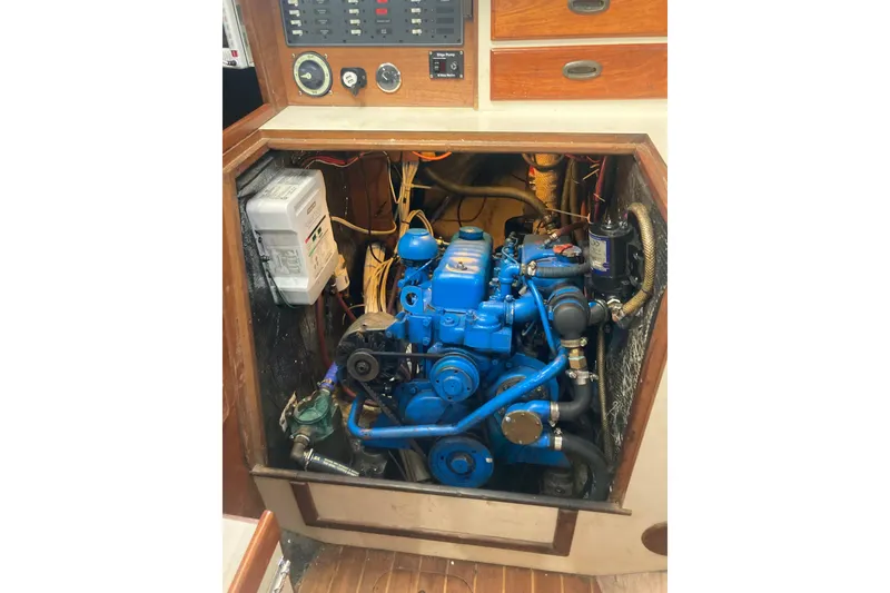 Slide: The Image of Engine compartment of a 1988 Cape Dory 36 sailboat, featuring a blue marine engine. - 28