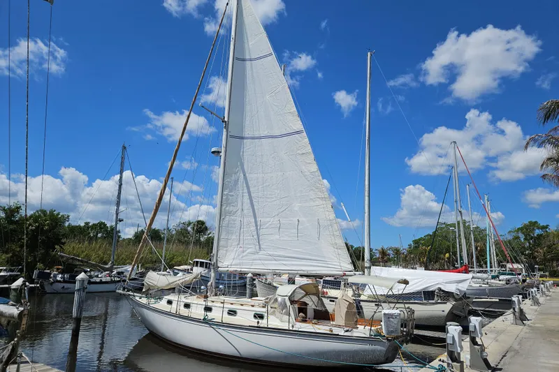 Slide: The Image of 1988 Cape Dory 38 sailboat docked at marina under clear blue sky. - 3