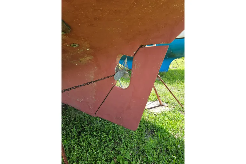 Slide: The Image of 1988 Cape Dory 36 sailboat rudder and hull on grassy ground. - 34